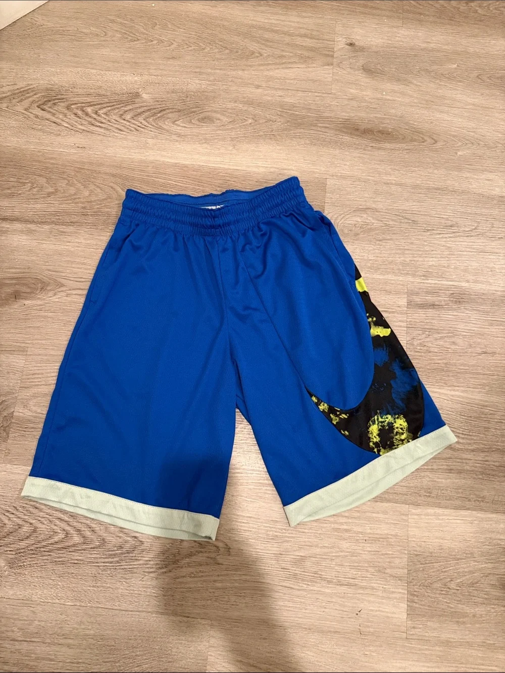 Nike Blue Athletic Shorts with Black Swoosh and Yellow Accent